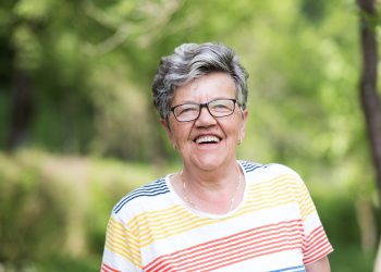 portrait of happy  senior woman with eyeglasses in nature