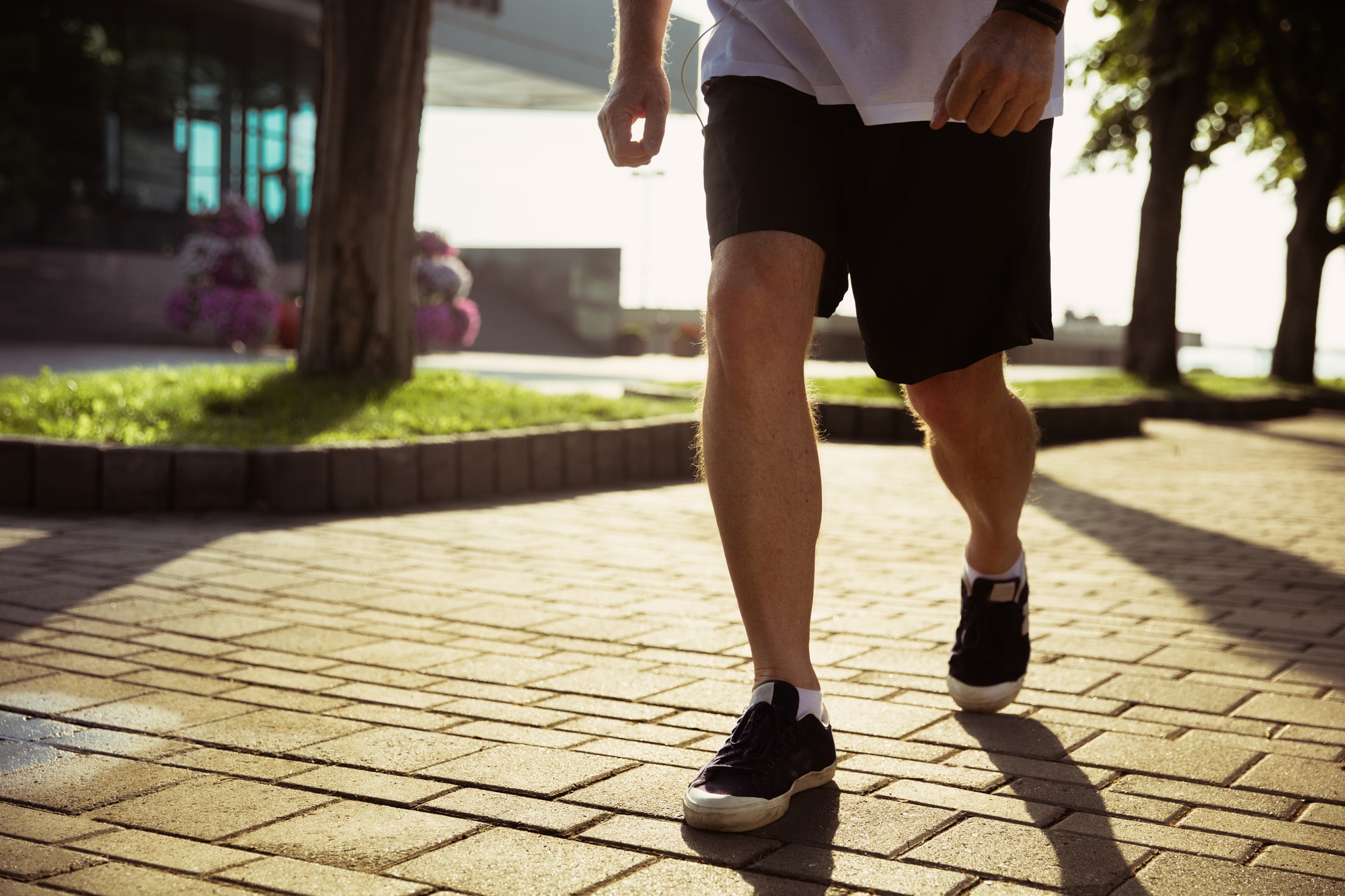 Senior man as runner with armband or fitness tracker at the city's street